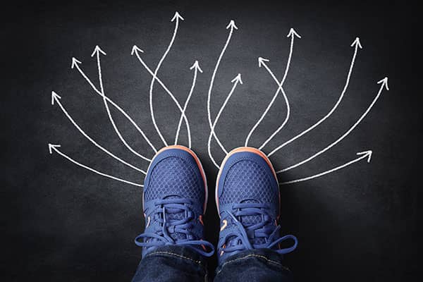 Looking down at feet with arrows showing directions to go in